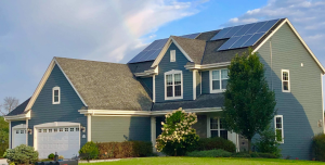 A two story single family home with two solar arrays on the roof