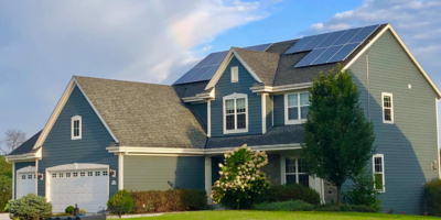 A two story single family home with two solar arrays on the roof