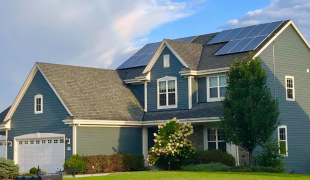 A two story single family home with two solar arrays on the roof